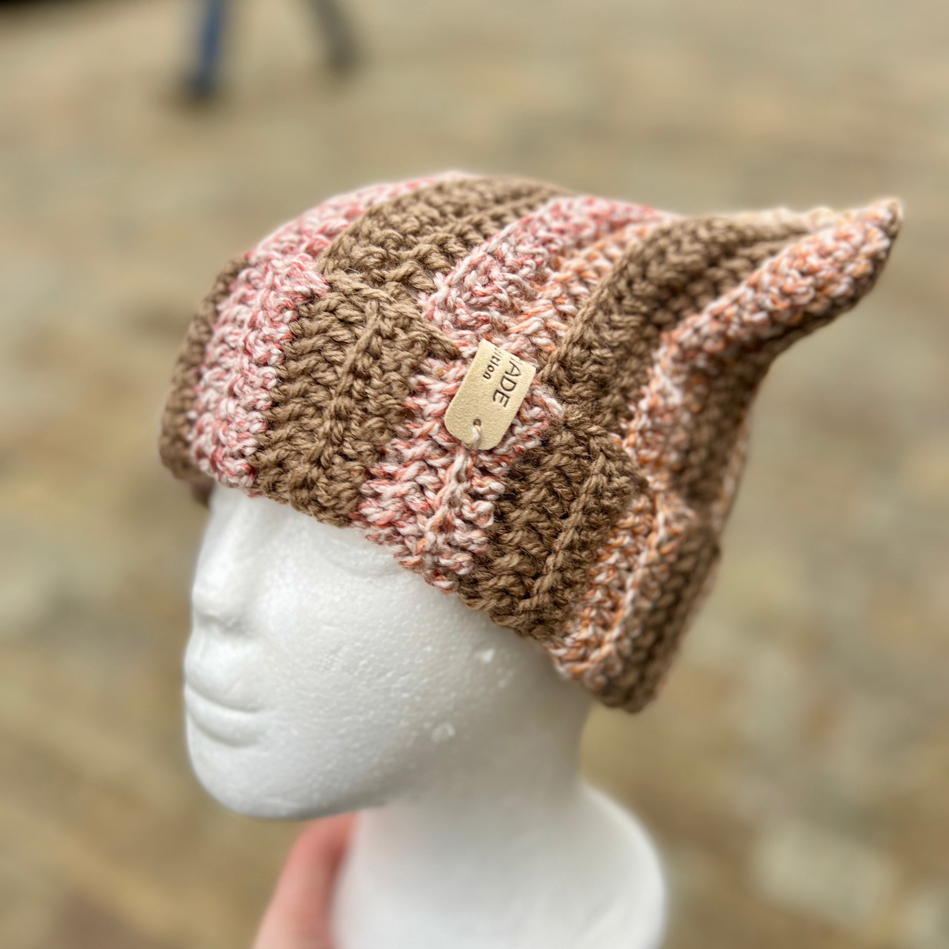 Knitted beanie on a mannequin head with a blurred background